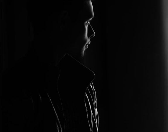 A very dark photo with an outline of a man as a representation of what a legally blind person may experience.
